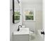Bathroom with new fixtures, modern mirror, white vanity and toilet, and a window at 2519 Miriam Ln, Decatur, GA 30032
