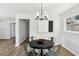 Dining area with decorative lighting, hardwood floors and black and white wall art at 2519 Miriam Ln, Decatur, GA 30032