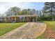 Attractive brick home with a covered carport, long driveway, and yellow front door at 2519 Miriam Ln, Decatur, GA 30032
