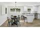 Eat-in kitchen boasting modern light fixture, white cabinets, granite counters and backyard views at 2519 Miriam Ln, Decatur, GA 30032