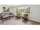 Sunlit living room featuring modern decor, hardwood floors, and large windows overlooking the front yard at 2519 Miriam Ln, Decatur, GA 30032