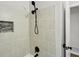 Modern shower featuring beige tiles, a mosaic niche, and a black rainfall shower head fixture at 2519 Miriam Ln, Decatur, GA 30032