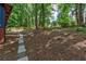 A naturally landscaped backyard offers a serene escape, surrounded by mature trees and lush greenery at 3348 Lynnray Dr, Atlanta, GA 30340
