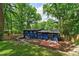 Backyard featuring a lush lawn, patio, and a view of the home's unique blue exterior at 3348 Lynnray Dr, Atlanta, GA 30340