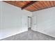 Bright bedroom with a wooden ceiling, neutral walls, and access to other rooms at 3348 Lynnray Dr, Atlanta, GA 30340