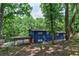 Back exterior of blue home featuring an outdoor patio and wooded views, creating a serene retreat at 3348 Lynnray Dr, Atlanta, GA 30340