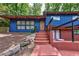 Stylish blue exterior with stone steps and a wooden door with a modern design at 3348 Lynnray Dr, Atlanta, GA 30340