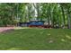 Exterior view of blue home with a lush front lawn and mature trees adding to the natural setting at 3348 Lynnray Dr, Atlanta, GA 30340