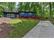 A charming exterior features a blue facade, a long driveway, and inviting landscaping at 3348 Lynnray Dr, Atlanta, GA 30340