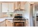 Kitchen boasts stainless steel appliances, a hood vent, and white subway tile backsplash at 3348 Lynnray Dr, Atlanta, GA 30340