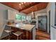 Bright kitchen boasts wood ceiling, counter seating, stainless appliances, and natural light at 3348 Lynnray Dr, Atlanta, GA 30340