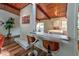 Open kitchen with breakfast bar, white cabinets, and wood paneled ceiling at 3348 Lynnray Dr, Atlanta, GA 30340