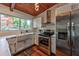 Kitchen with stainless steel appliances, white cabinets and a large farmhouse sink at 3348 Lynnray Dr, Atlanta, GA 30340