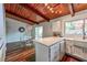 Eat-in kitchen features an island, breakfast area, white cabinets, and wood ceiling at 3348 Lynnray Dr, Atlanta, GA 30340
