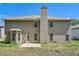 View of backyard with patio, grassy area, and neutral two-story home under blue sky at 349 Pennant Ln, Fairburn, GA 30213