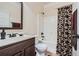 Bathroom featuring a vanity, toilet, and shower-tub combo with patterned curtain at 349 Pennant Ln, Fairburn, GA 30213