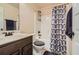 Bathroom features a shower-tub combo, toilet, and sink vanity with a dark wood finish at 349 Pennant Ln, Fairburn, GA 30213