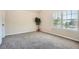 Bedroom featuring plush carpeting, neutral paint, and a large window with blinds at 349 Pennant Ln, Fairburn, GA 30213