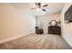 Carpeted bedroom showcases a ceiling fan, dresser, and comfortable armchair at 349 Pennant Ln, Fairburn, GA 30213
