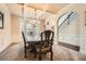 Elegant dining room featuring a coffered ceiling, wainscoting, chandelier, and staircase access at 349 Pennant Ln, Fairburn, GA 30213