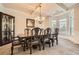 Dining room with classic dark wood furniture, wainscoting, chandelier, and large bay window at 349 Pennant Ln, Fairburn, GA 30213