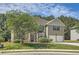 Traditional home boasts manicured lawn, mature trees, and a two-car garage at 349 Pennant Ln, Fairburn, GA 30213