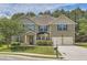 Charming two-story home with a well-manicured lawn, attached two-car garage, and inviting front porch at 349 Pennant Ln, Fairburn, GA 30213