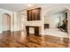 Open area with hardwood floors, custom cabinetry, and fireplace at 349 Pennant Ln, Fairburn, GA 30213