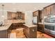 Bright kitchen featuring granite counters, stainless steel appliances, and center island with hardwood floors at 349 Pennant Ln, Fairburn, GA 30213