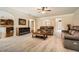Open-concept living room with neutral tones, plush carpeting, fireplace, and arched doorways at 349 Pennant Ln, Fairburn, GA 30213