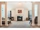Open living room features a fireplace, neutral carpet, and large columns at 349 Pennant Ln, Fairburn, GA 30213