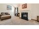 Cozy living room space with a fireplace, comfortable seating, and neutral tones at 349 Pennant Ln, Fairburn, GA 30213