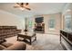 Bright living room features a cozy fireplace, plush carpeting, and abundant natural light at 349 Pennant Ln, Fairburn, GA 30213