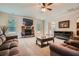Comfortable living room boasts a stone fireplace, neutral carpeting, and access to other living areas at 349 Pennant Ln, Fairburn, GA 30213