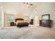 Large main bedroom featuring vaulted ceilings, carpet, and an ensuite bathroom at 349 Pennant Ln, Fairburn, GA 30213