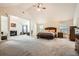 Spacious main bedroom with high ceilings, carpet, and sitting area with fireplace at 349 Pennant Ln, Fairburn, GA 30213