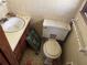 Small, dirty bathroom featuring a sink, toilet, and vanity at 5804 S South Gordon Sw Rd, Austell, GA 30168