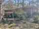 Cozy brick home featuring a covered patio and a yard with mature trees and shrubs at 5804 S South Gordon Sw Rd, Austell, GA 30168