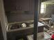 Dirty, old kitchen with clutter, cabinets, and sink at 5804 S South Gordon Sw Rd, Austell, GA 30168