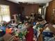 Cluttered living room with wood paneled walls and a window at 5804 S South Gordon Sw Rd, Austell, GA 30168