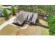 Aerial view of a house with a manicured lawn, long driveway and mature trees at 20 Saddle Wood Dr, Dallas, GA 30157