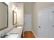 Bathroom vanity featuring double undermount sinks, granite countertop, and wood-look flooring at 20 Saddle Wood Dr, Dallas, GA 30157