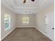 Spacious bedroom with tray ceiling, large windows, and neutral carpeting at 20 Saddle Wood Dr, Dallas, GA 30157