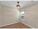 Cozy bedroom featuring a small window, neutral walls, neutral carpet and a unique light fixture at 20 Saddle Wood Dr, Dallas, GA 30157