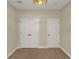 Neutral bedroom featuring closet, neutral walls, neutral carpet and a unique light fixture at 20 Saddle Wood Dr, Dallas, GA 30157