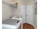 Laundry room featuring washer and dryer, storage shelf, and wood flooring at 20 Saddle Wood Dr, Dallas, GA 30157