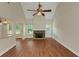 Bright living room featuring a stone fireplace, high ceilings, and wood floors at 20 Saddle Wood Dr, Dallas, GA 30157