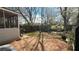 Fenced backyard featuring mature trees providing shade, patio, and a space for outdoor activities and gardening at 30 Crestfield Cir, Covington, GA 30016