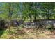 Fenced backyard featuring mature trees, offering a private outdoor retreat with room to personalize at 30 Crestfield Cir, Covington, GA 30016