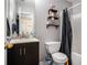 Clean bathroom featuring a vanity, mirror, shelves, toilet and tub at 30 Crestfield Cir, Covington, GA 30016